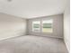 A bright bedroom featuring carpet flooring and windows with blinds at 9209 Sw 58Th Cir, Ocala, FL 34476