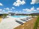 Expansive community pool features numerous lounge chairs for sunbathing and relaxation on a beautiful sunny day at 9209 Sw 58Th Cir, Ocala, FL 34476