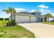 Charming light blue home boasting a well-manicured lawn and a spacious three-car garage, in a Gathering-friendly neighborhood at 9209 Sw 58Th Cir, Ocala, FL 34476