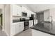 This kitchen features stainless steel appliances, granite countertops, and white cabinets at 9209 Sw 58Th Cir, Ocala, FL 34476