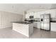Bright kitchen featuring granite countertops, stainless steel appliances, and a kitchen island at 9209 Sw 58Th Cir, Ocala, FL 34476