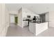 Bright open-concept kitchen featuring granite countertops, white cabinetry, stainless steel appliances, and versatile island at 9209 Sw 58Th Cir, Ocala, FL 34476