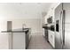 Bright kitchen with stainless steel appliances, granite countertops, and a kitchen island at 9209 Sw 58Th Cir, Ocala, FL 34476
