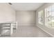 Bright office space with sleek tile flooring, neutral walls, modern desk, and ample natural light from large windows at 9209 Sw 58Th Cir, Ocala, FL 34476
