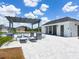 Community pool area featuring a pergola, lounge chairs, and a modern pool house for comfortable relaxation at 9209 Sw 58Th Cir, Ocala, FL 34476