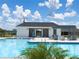 Community pool featuring a pool house and ample lounging areas for residents to enjoy on sunny days at 9209 Sw 58Th Cir, Ocala, FL 34476