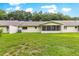 Wide view of backyard featuring lush green grass and an enclosed sunroom at 9367 Sw 83Rd Ave # C, Ocala, FL 34481
