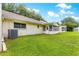Spacious backyard featuring lush green grass and an enclosed sunroom at 9367 Sw 83Rd Ave # C, Ocala, FL 34481