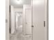 Long hallway with neutral carpet and white doors at 9367 Sw 83Rd Ave # C, Ocala, FL 34481