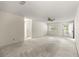 Expansive living room with neutral carpet, ceiling fan, and entry door at 9367 Sw 83Rd Ave # C, Ocala, FL 34481