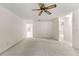 Bright living room featuring neutral carpet, a ceiling fan, and an open layout at 9367 Sw 83Rd Ave # C, Ocala, FL 34481