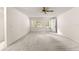 Bright living room with neutral carpet, ceiling fan, and entrance door to outside at 9367 Sw 83Rd Ave # C, Ocala, FL 34481