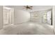 Bright living room with neutral carpet, ceiling fan, window, and entrance door to outside at 9367 Sw 83Rd Ave # C, Ocala, FL 34481