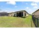 Spacious backyard with black metal fence and mature landscaping at 9634 Sw 67Th St, Ocala, FL 34481