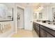 Bathroom featuring double vanity with granite countertops and custom cabinetry at 9634 Sw 67Th St, Ocala, FL 34481