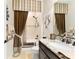Bathroom with granite countertop, dark wood cabinets, and decorative mirror at 9634 Sw 67Th St, Ocala, FL 34481