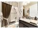 Bathroom with granite countertop, dark wood cabinets, and decorative mirror at 9634 Sw 67Th St, Ocala, FL 34481