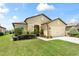 Well-manicured front yard showcasing a charming single-Gathering home with a two-car garage at 9634 Sw 67Th St, Ocala, FL 34481