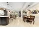 Open-concept kitchen and dining area with large island and modern lighting at 9634 Sw 67Th St, Ocala, FL 34481