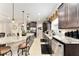 Spacious kitchen with stainless steel appliances, granite countertops, and a large center island with pendant lighting at 9634 Sw 67Th St, Ocala, FL 34481