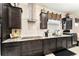 The kitchen features dark cabinetry, a stainless steel range hood, and a white tiled backsplash at 9634 Sw 67Th St, Ocala, FL 34481