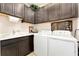 Laundry room featuring modern washer and dryer with dark wood cabinets at 9634 Sw 67Th St, Ocala, FL 34481