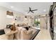 The living room has neutral paint and tile with a large ceiling fan and access to the patio at 9634 Sw 67Th St, Ocala, FL 34481