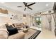 A spacious living room is well lit with tile floors, neutral paint, and a ceiling fan at 9634 Sw 67Th St, Ocala, FL 34481