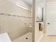 Tiled walk-in shower with decorative window and bench seating at 9634 Sw 67Th St, Ocala, FL 34481