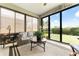Inviting sunroom with large windows offering a view of the manicured backyard at 9634 Sw 67Th St, Ocala, FL 34481