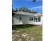 View of the home's rear featuring a patio and a door that offers convenient outdoor access at 9711 Sw 97Th Pl, Ocala, FL 34481