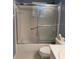 This bathroom boasts a tub and shower combination with a sliding glass door enclosure at 9711 Sw 97Th Pl, Ocala, FL 34481