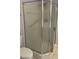 This bathroom showcases an enclosed shower with silver trim and stone tile features at 9711 Sw 97Th Pl, Ocala, FL 34481