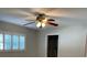 This bedroom features a ceiling fan and a window with white shutters, providing natural light at 9711 Sw 97Th Pl, Ocala, FL 34481