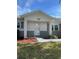Charming front porch with brick accents and manicured landscaping at this inviting home at 9711 Sw 97Th Pl, Ocala, FL 34481