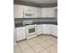 Kitchen with white cabinets, modern appliances, and tile flooring at 9711 Sw 97Th Pl, Ocala, FL 34481