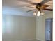 A view of the living room showing the ceiling fan and adjacent door at 9711 Sw 97Th Pl, Ocala, FL 34481