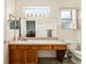 Clean bathroom featuring a long vanity with mirror, a toilet, a window and a partial view into bedroom at 13100 Se 93Rd Terrace Rd, Summerfield, FL 34491