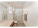Bright bathroom featuring a glass-enclosed shower, modern fixtures, and tile flooring at 13100 Se 93Rd Terrace Rd, Summerfield, FL 34491