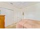 Cozy bedroom with neutral carpet, ceiling fan, and closet for organized living at 13100 Se 93Rd Terrace Rd, Summerfield, FL 34491