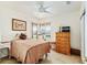 Cozy bedroom with a large window for lots of natural light, a ceiling fan, and neutral decor at 13100 Se 93Rd Terrace Rd, Summerfield, FL 34491
