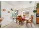 Light-filled dining room showcases a wood table, sliding glass doors to a sunroom, and natural light at 13100 Se 93Rd Terrace Rd, Summerfield, FL 34491