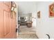 Entryway view into a living room with neutral carpet and comfortable furnishings at 13100 Se 93Rd Terrace Rd, Summerfield, FL 34491