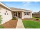 Inviting front porch with seating, neat landscaping, and decorative door accents at 13100 Se 93Rd Terrace Rd, Summerfield, FL 34491