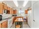 Functional kitchen with wooden cabinets, an island with seating, modern appliances, and lots of natural light at 13100 Se 93Rd Terrace Rd, Summerfield, FL 34491