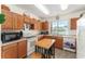 Functional kitchen with wooden cabinets, modern appliances, and natural light at 13100 Se 93Rd Terrace Rd, Summerfield, FL 34491