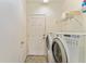 Convenient laundry room with washer, dryer, and shelving for efficient organization at 13100 Se 93Rd Terrace Rd, Summerfield, FL 34491