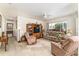 Cozy living room with plush seating, a ceiling fan, and a large window at 13100 Se 93Rd Terrace Rd, Summerfield, FL 34491