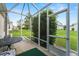 Enjoy the outdoors bug-free on this home's screened porch overlooking the landscaped backyard at 13100 Se 93Rd Terrace Rd, Summerfield, FL 34491