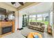 Inviting sunroom with a fireplace, comfortable seating, and a bright and airy atmosphere at 13100 Se 93Rd Terrace Rd, Summerfield, FL 34491